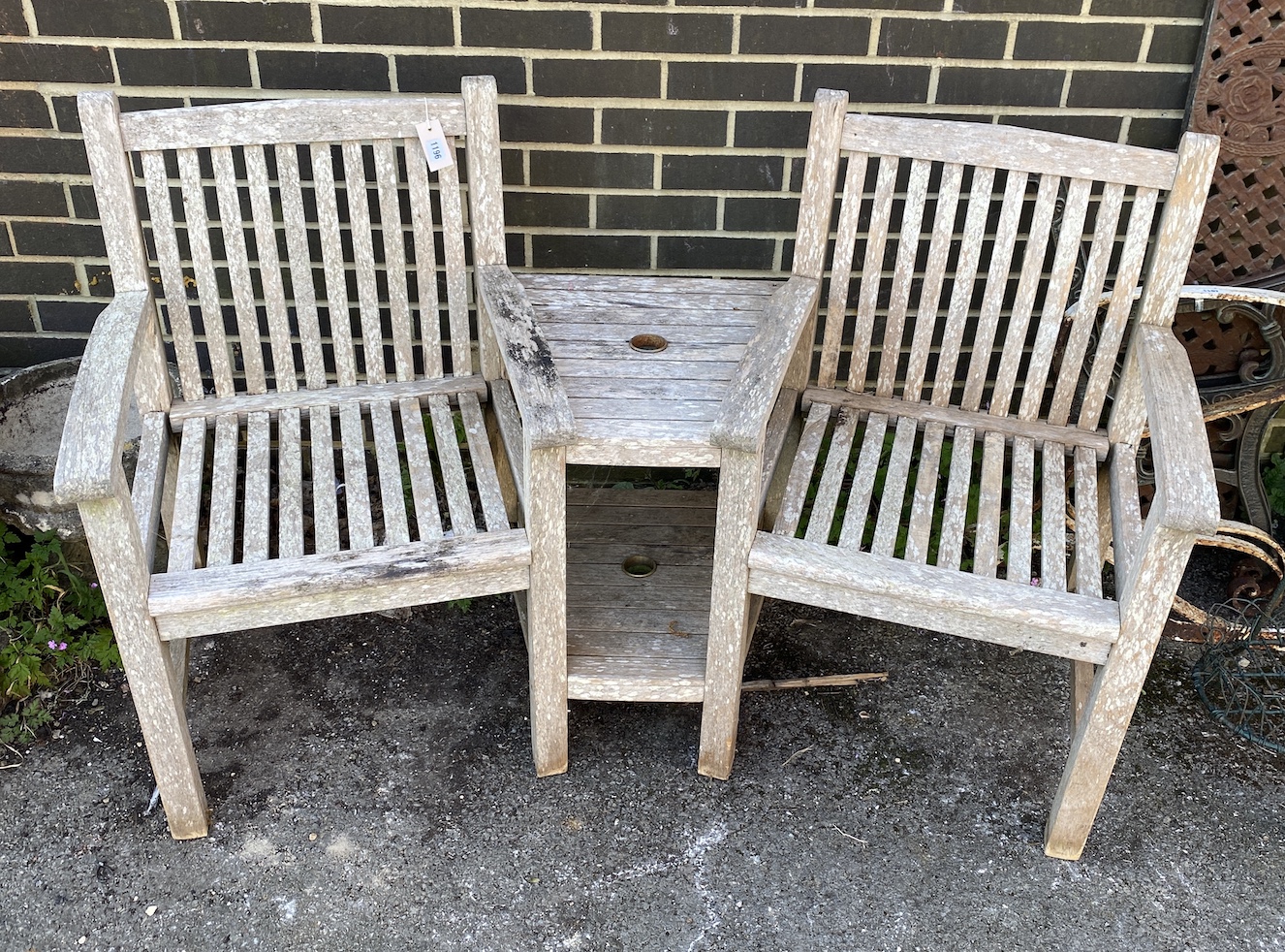 A weathered teak garden double seat, width 156cm, height 90cm